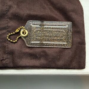 Coach Poopy Clear and gold Glitter Hang Tag